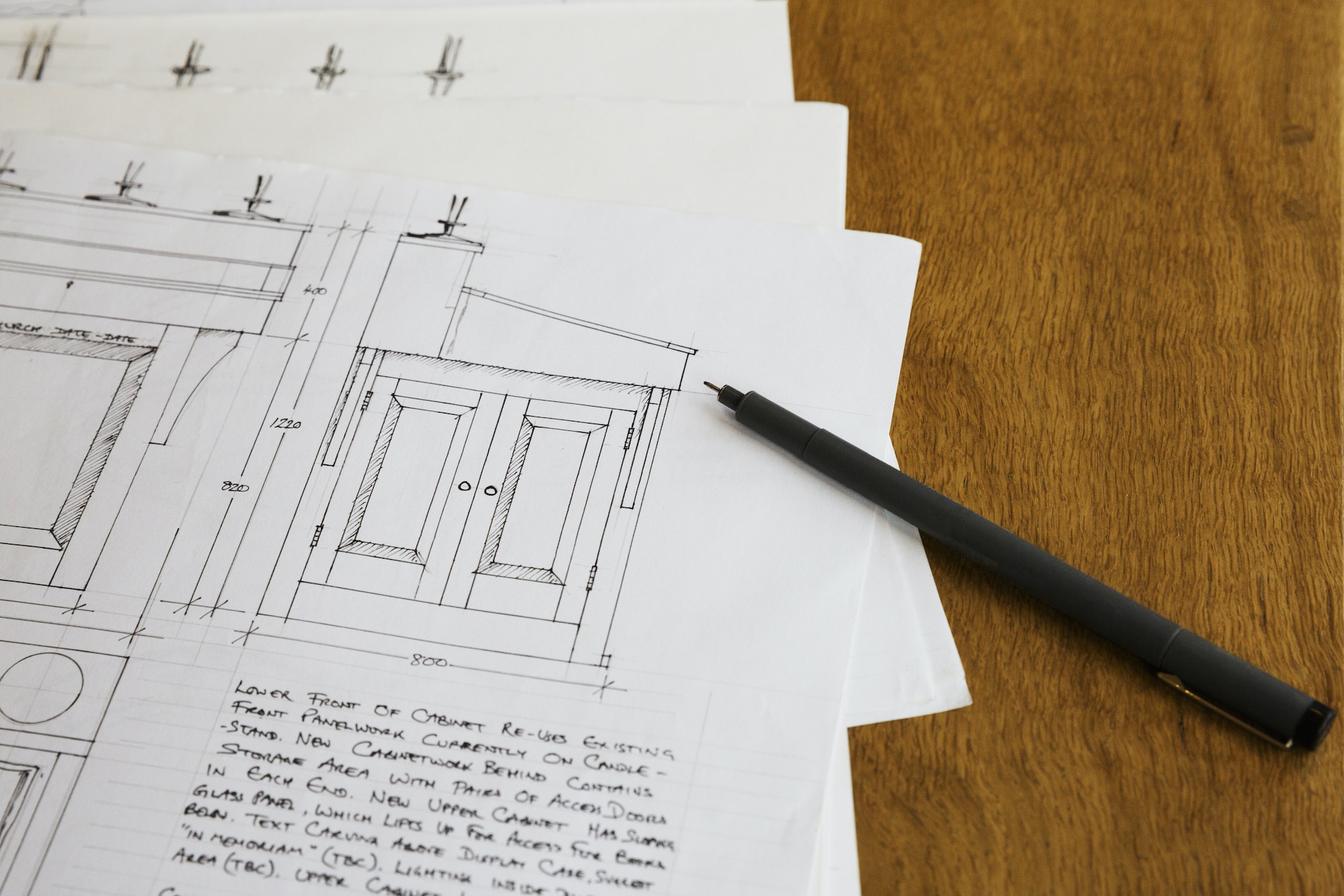 Close up of design drawings for a cabinet, handwritten notes.